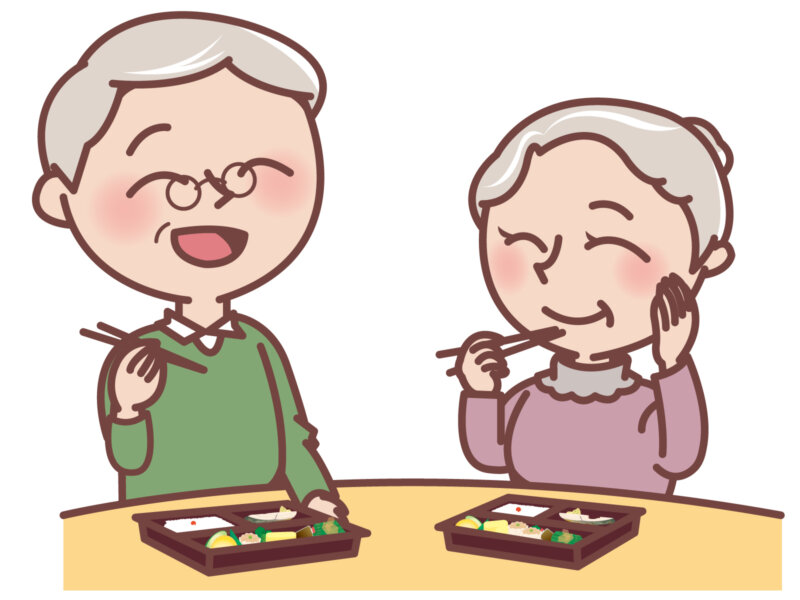 仲良く弁当を食べる高齢者